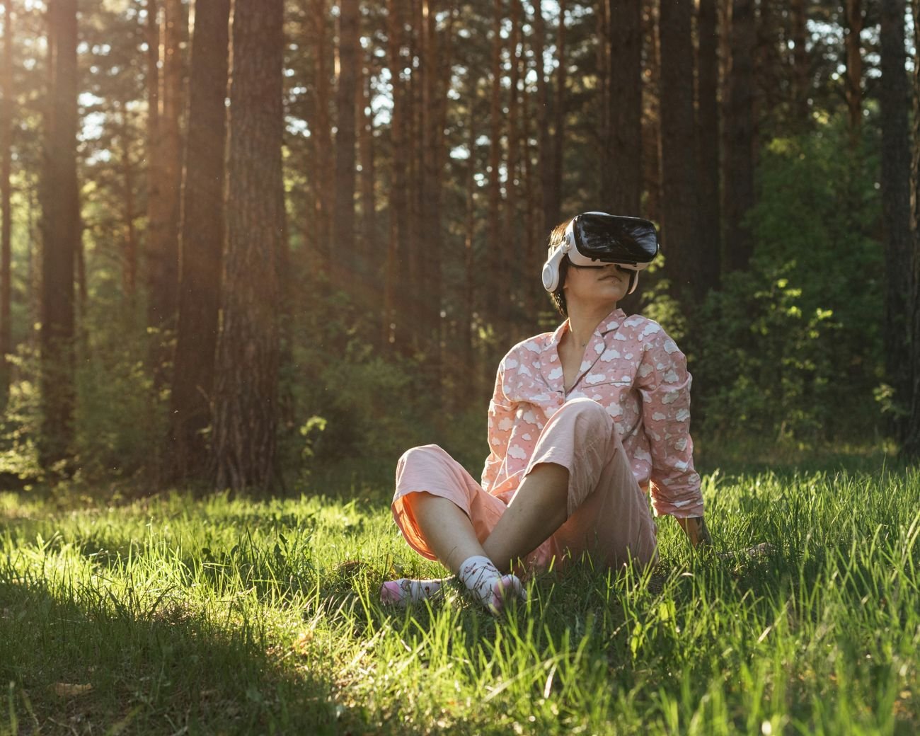 A listener wearing a VR headset in a sunlit forest